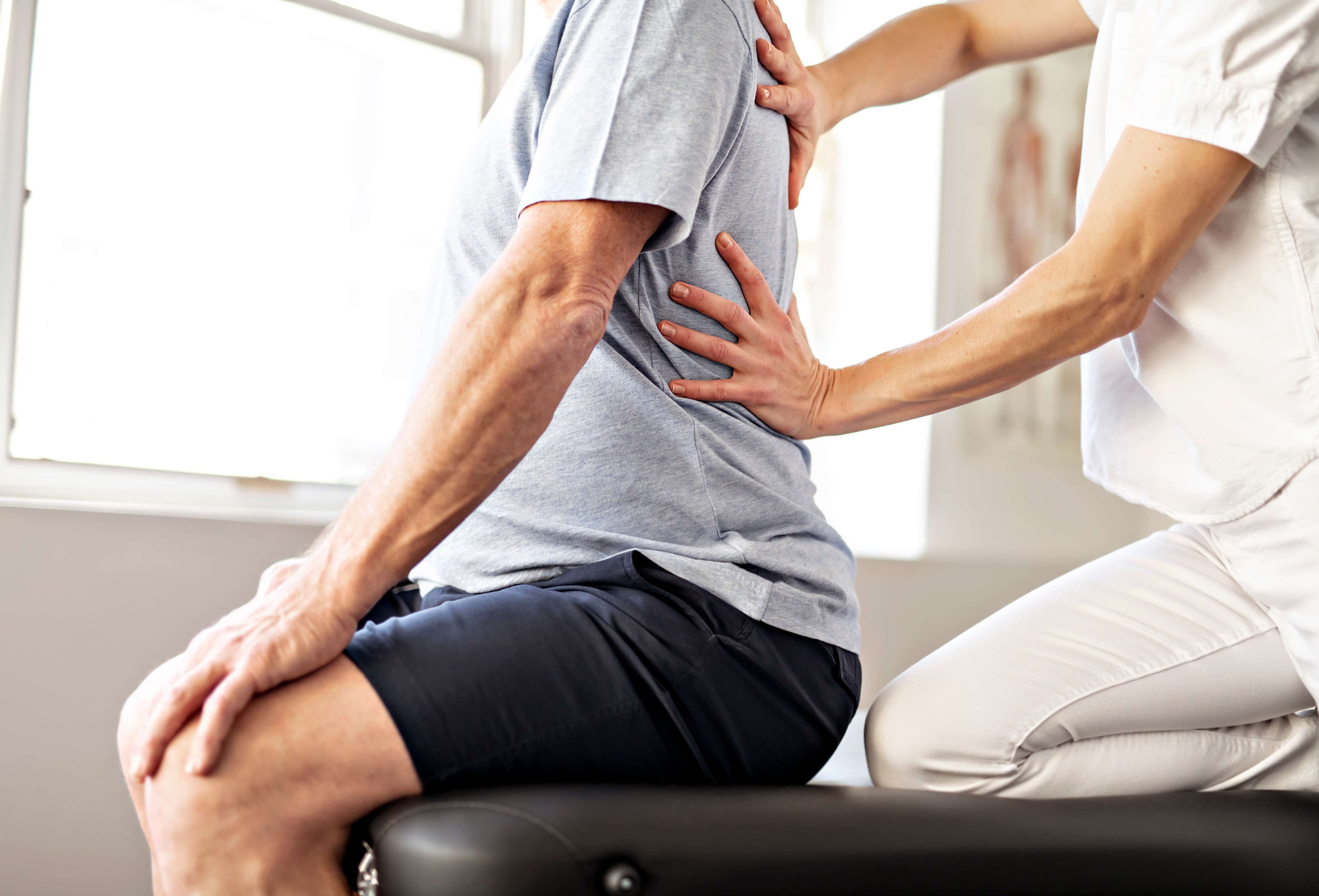 A Modern rehabilitation physiotherapy worker with senior client